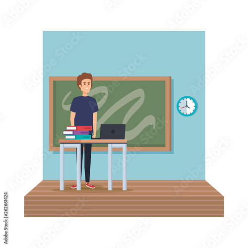 teacher in desk with laptop and books classroom scene