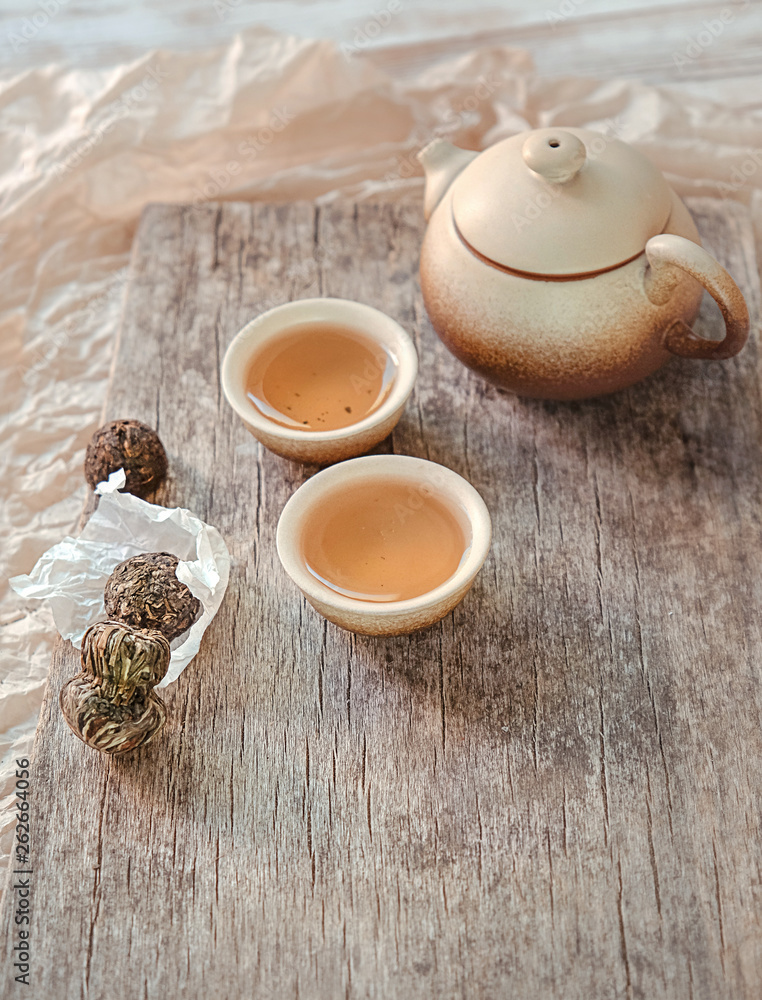 japanese or chinese tea. tea party, tea ceremony in Japanese style of wabi Sabi. beautiful composition with kettle, cups and tea leaves. soft selective focus japanese or chinese tea. tea party, tea ceremony in Japanese style of wabi Sabi. beautiful composition with kettle, cups and tea leaves. soft selective focus