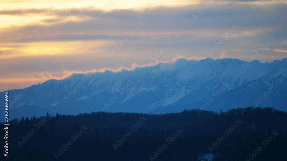 Snowed mountain peak and colored sky, beautiful nature panorama Snowed mountain peak and colored sky, beautiful nature panorama