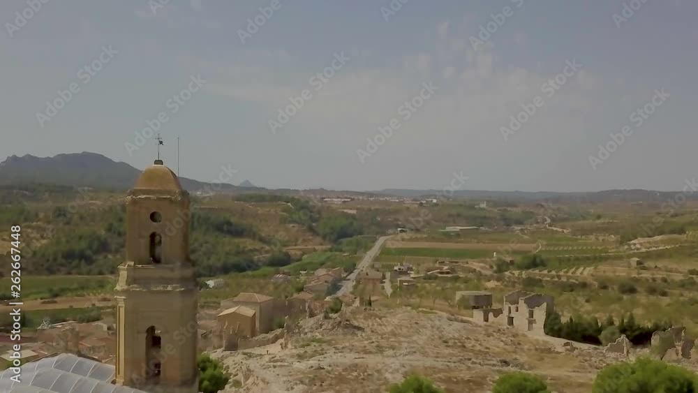aerial image of Corbera de Ebre cathedral with mountains in the background aerial image of Corbera de Ebre cathedral with mountains in the background
