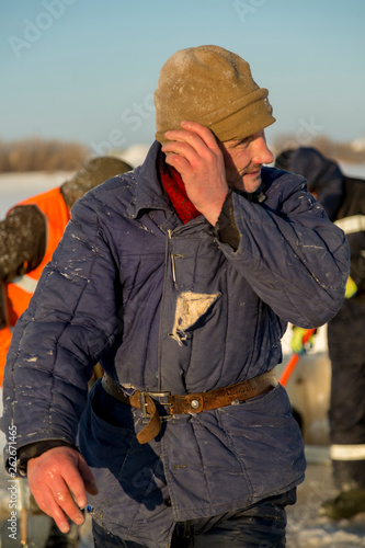 Portrait of a worker in a blue padded jacket