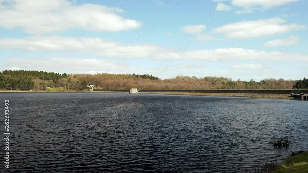 Low Aerial Flyover of Fewston Reservoir from Banks to Water on Sunny Spring Day Low Aerial Flyover of Fewston Reservoir from Banks to Water on Sunny Spring Day
