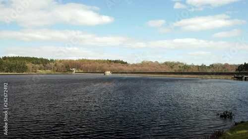 Low Aerial Flyover of Fewston Reservoir from Banks to Water on Sunny Spring Day photo