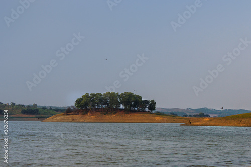 Small island in the middle of the Cacaban reservoir, Tegal, Indonesia photo