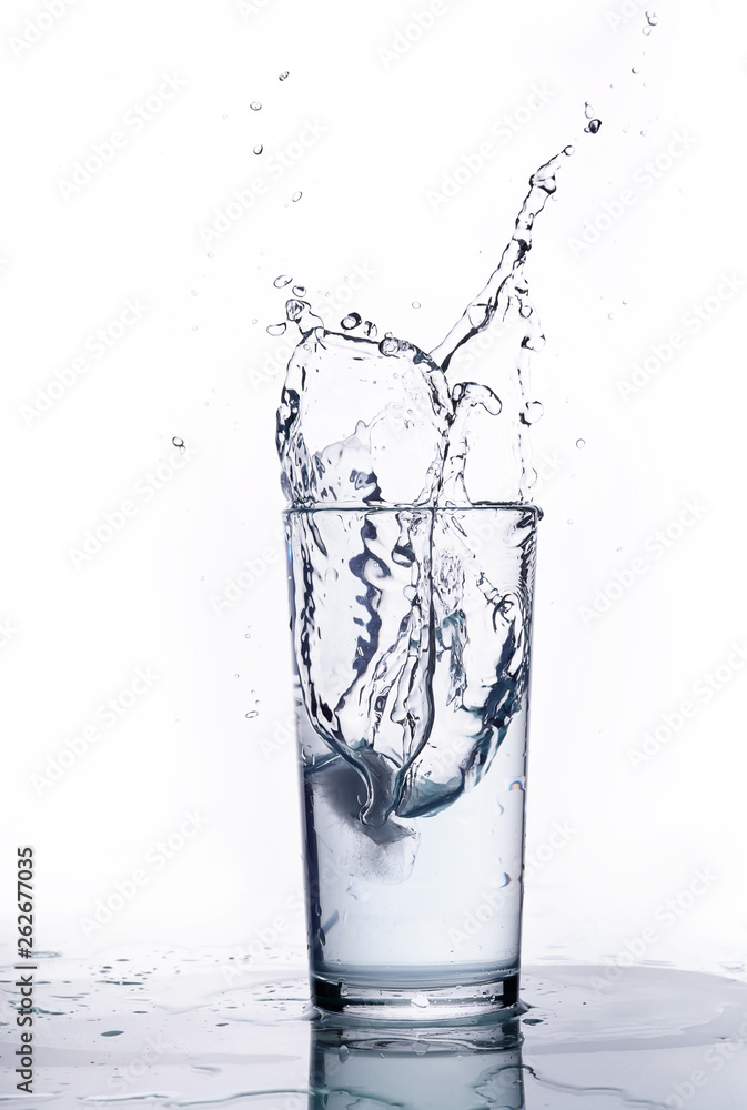 splash of water in a glass beaker. White background. splash of water in a glass beaker. White background.