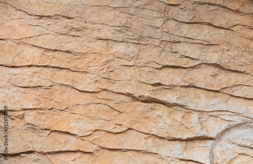 Texture and background of yellow stone. Wavy stone texture
