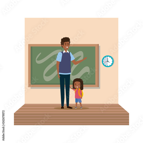 teacher male with schoolgirl in classroom