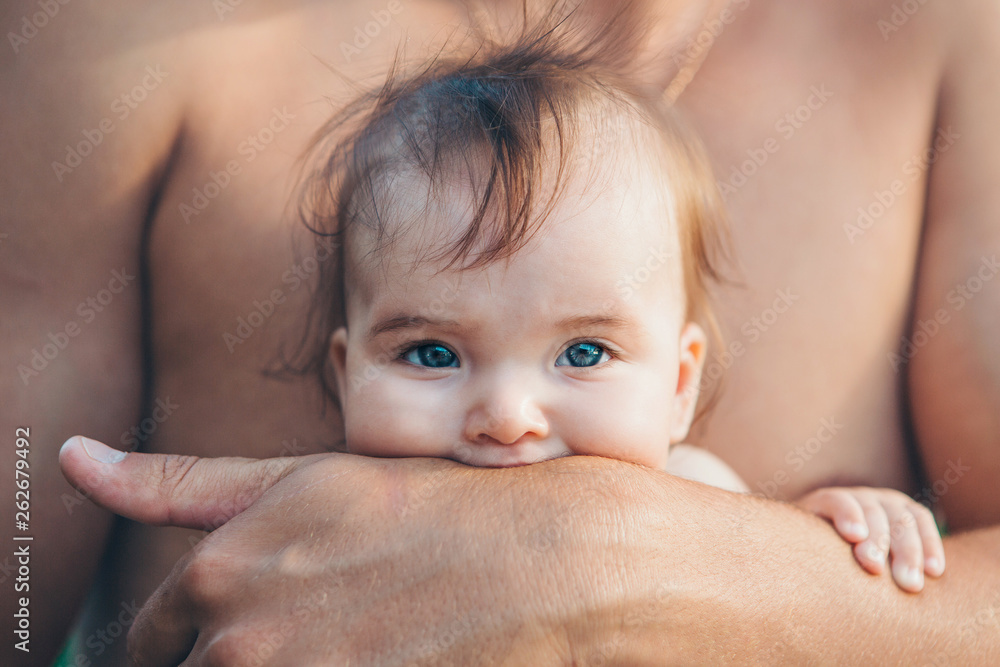 baby in the arms of the father. man holding a child baby in the arms of the father. man holding a child