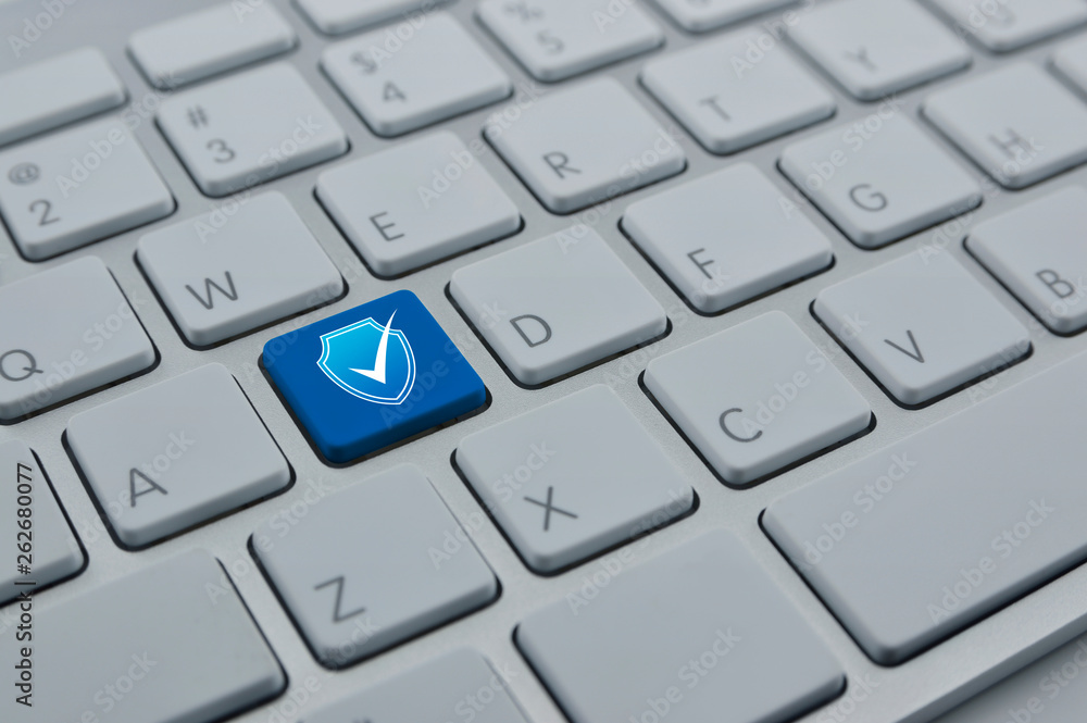 Security shield with check mark flat icon on modern computer keyboard button, Technology internet cyber security and anti virus concept Security shield with check mark flat icon on modern computer keyboard button, Technology internet cyber security and anti virus concept