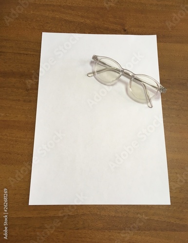 blank paper on the table and glasses