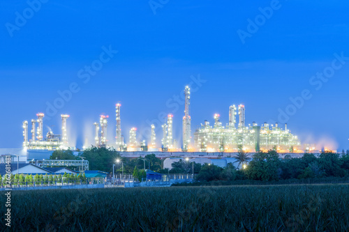 Industrial plant at twilight. Petrochemical oil refinery factory plant.
