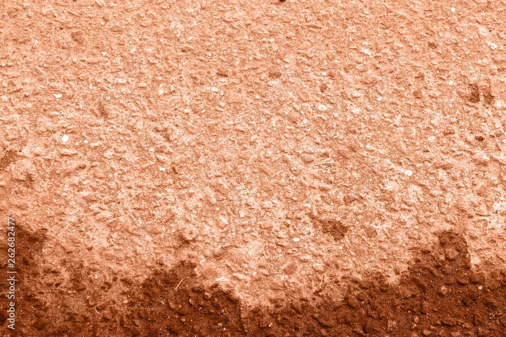 Old asphalt surface texture background close up. Orange color toned