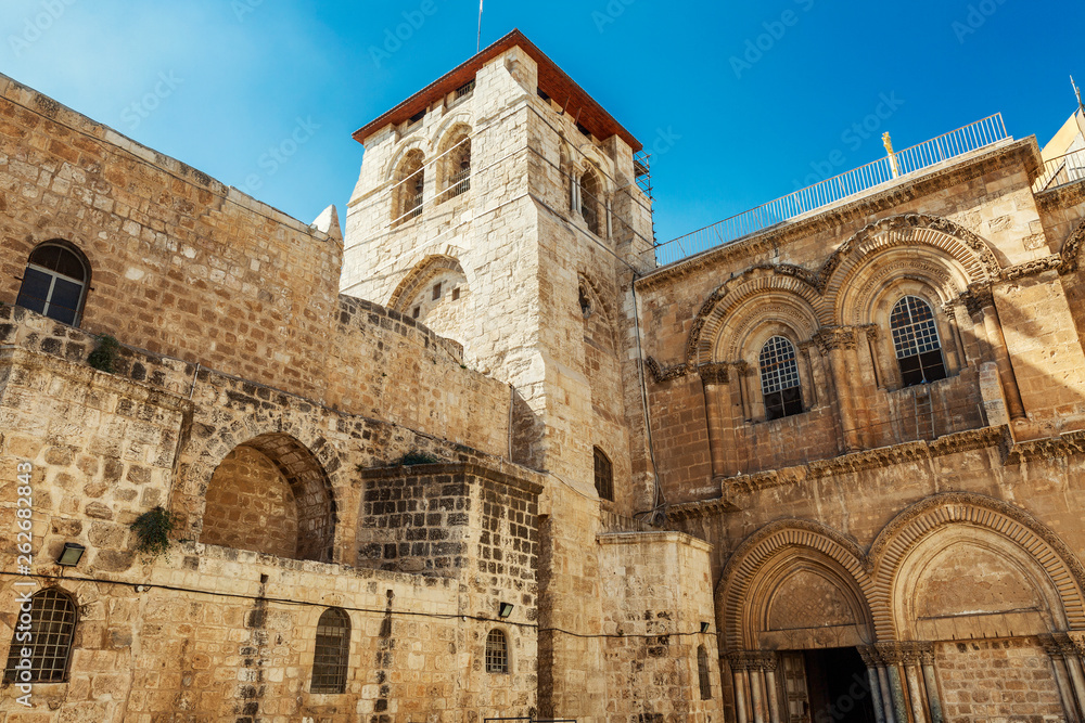 Facade of the Temple of the Holy Sepulcher in Jerusalem. Bright blue sky on a sunny day.