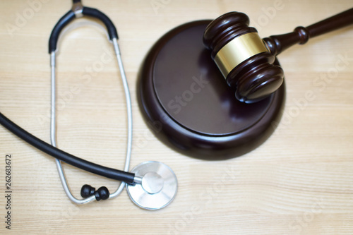 Judges gavel  sounding block and stethoscope on light wooden background  selective focus at sdf. Medical law system  health law  medical jurisprudence and justice concept.