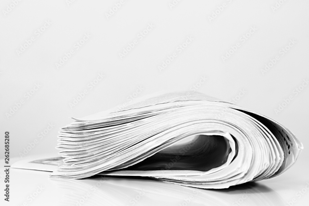 newspaper rolled up and sitting on a table newspaper rolled up and sitting on a table