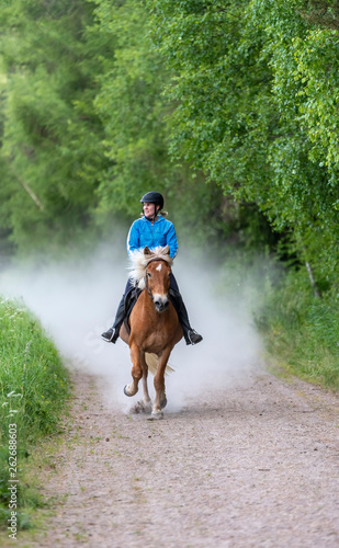 Woman horseback riding © citikka