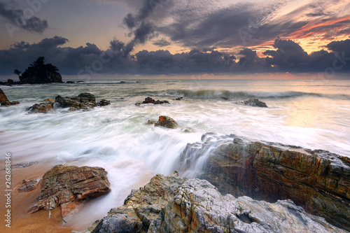 Rushing waves over the rocky beach in Pantai Kemasik, Terengganu Malaysia 