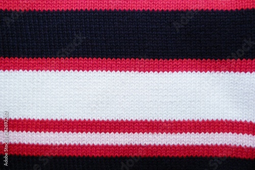 striped knitted fabric close-up knitted fabric macro background lines geometrical pattern black red white
