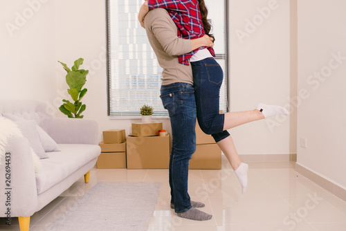 Just married couple of young man and woman feeling unbelievable chilling in their new house