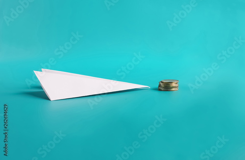 Cheap Flight low cost Concept. Paper plane and coins