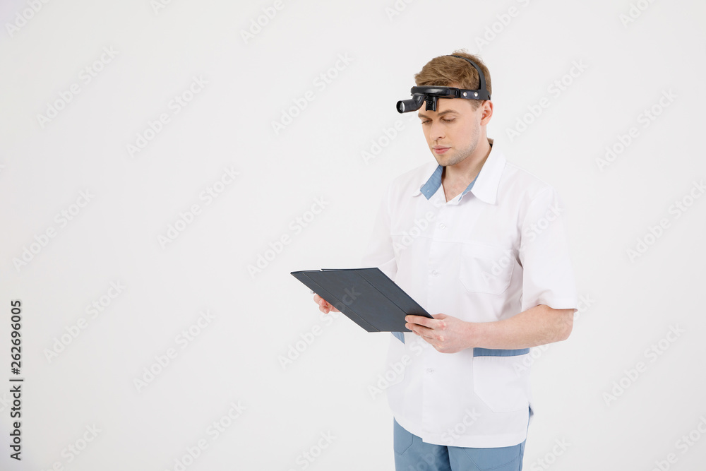Portrait smiling otolaryngologist doctor with medical mirror on head isolated on white Portrait smiling otolaryngologist doctor with medical mirror on head isolated on white
