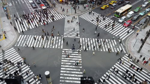 TOKYO,JAPAN-MARCH 30,2019:People passing the street crossing in Ginza district, Tokyo. Crosswalk. Intersection in Tokyo,Japan photo
