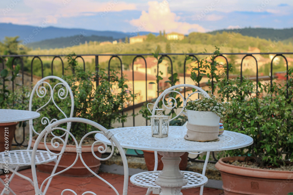 view of Chianti region in Tuscany from the terrace with wrought furniture, Tuscany, Italy