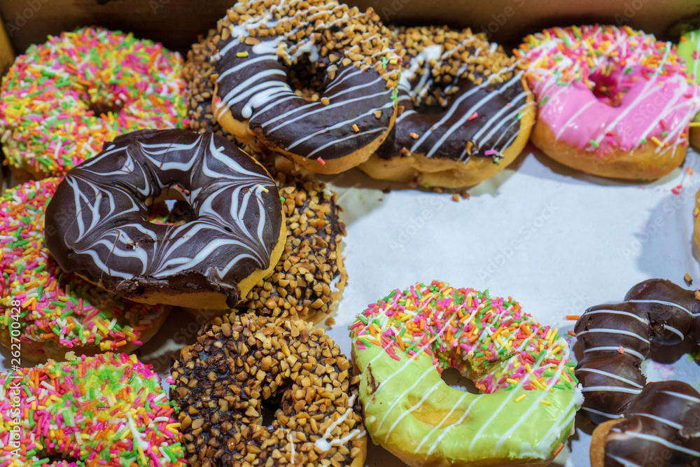 Fresh prepared asian doughnuts / Set of donuts of various colors in box. 