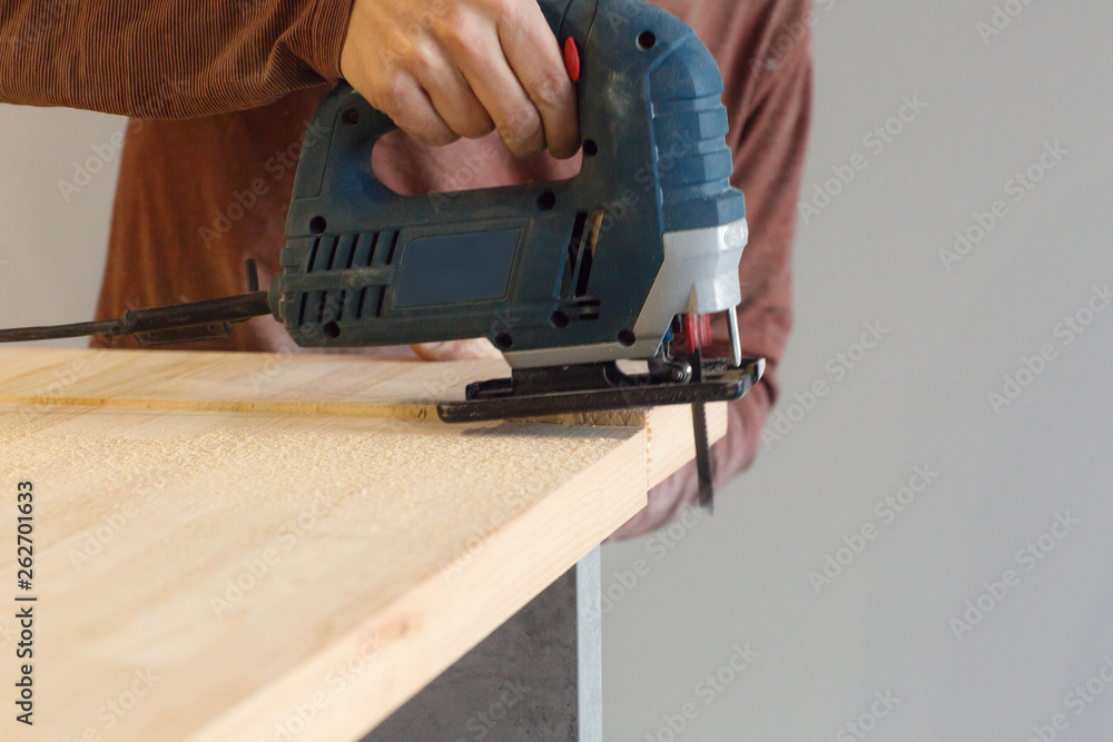 Carpenter working with circular saw. Home renovation