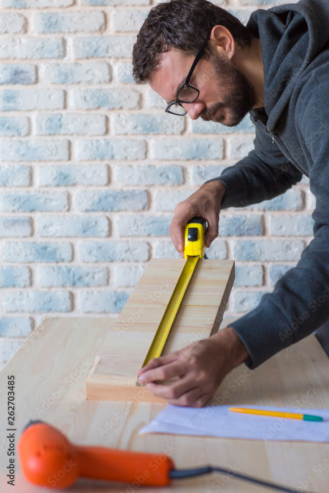 Young man working on his house or apartment renovation project. Young man working on his house or apartment renovation project.