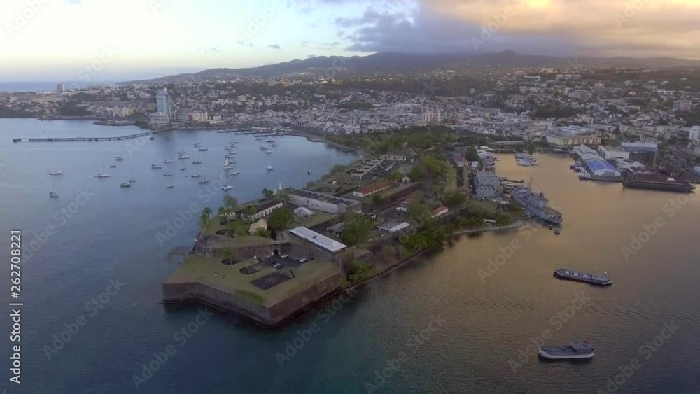Aerial Drone flight around fort saint louis in fort de france on martinique in the carribean. after sunrise, yachts are anchoring in front of coastline. Aerial Drone flight around fort saint louis in fort de france on martinique in the carribean. after sunrise, yachts are anchoring in front of coastline.