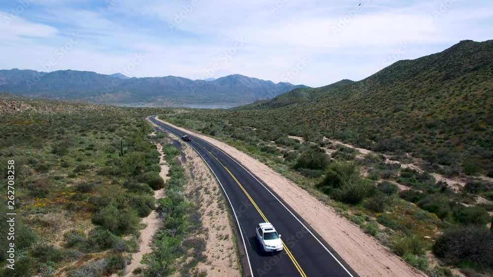 Aerial slow ascent from road level where traffic is heading back to Scottsdale from Bartlett Lake, Tonto National Forest, Sonoran Desert, Arizona, Concept: transportation, travel, springtime Aerial slow ascent from road level where traffic is heading back to Scottsdale from Bartlett Lake, Tonto National Forest, Sonoran Desert, Arizona, Concept: transportation, travel, springtime