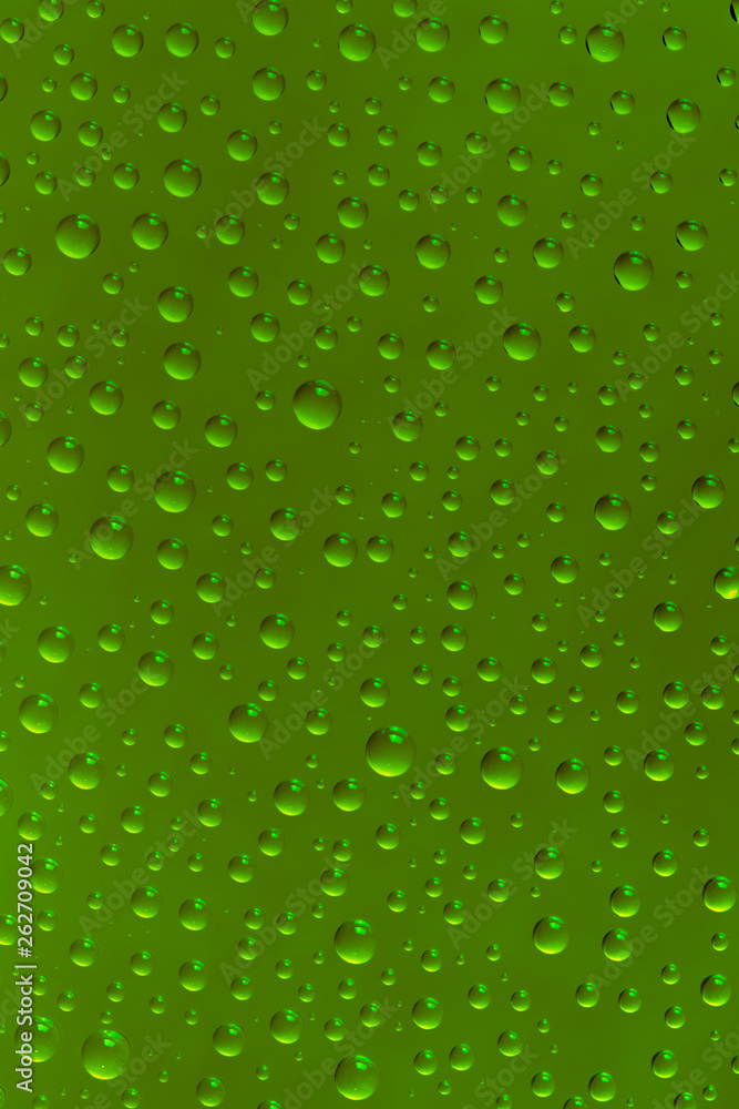 Beautiful water drops of the correct form on a bright green background Beautiful water drops of the correct form on a bright green background