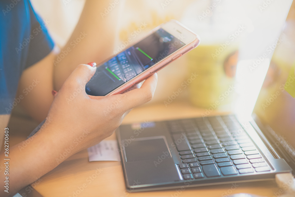 Businesswoman at workplace Woman working in home office. Closeup view of hand women touching mobile phone Businesswoman at workplace Woman working in home office. Closeup view of hand women touching mobile phone