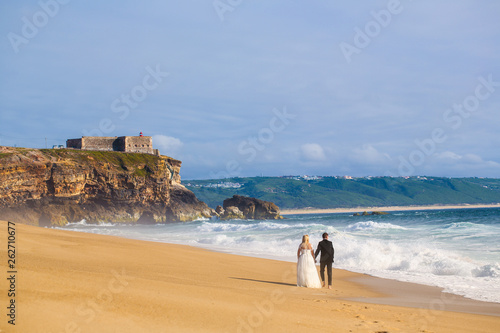 Beautiful wedding couple posing on beach