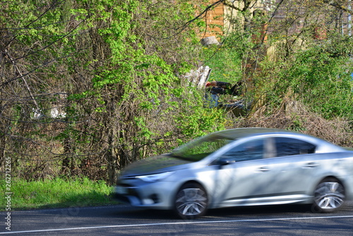 european cars passing by with green landscape in the background