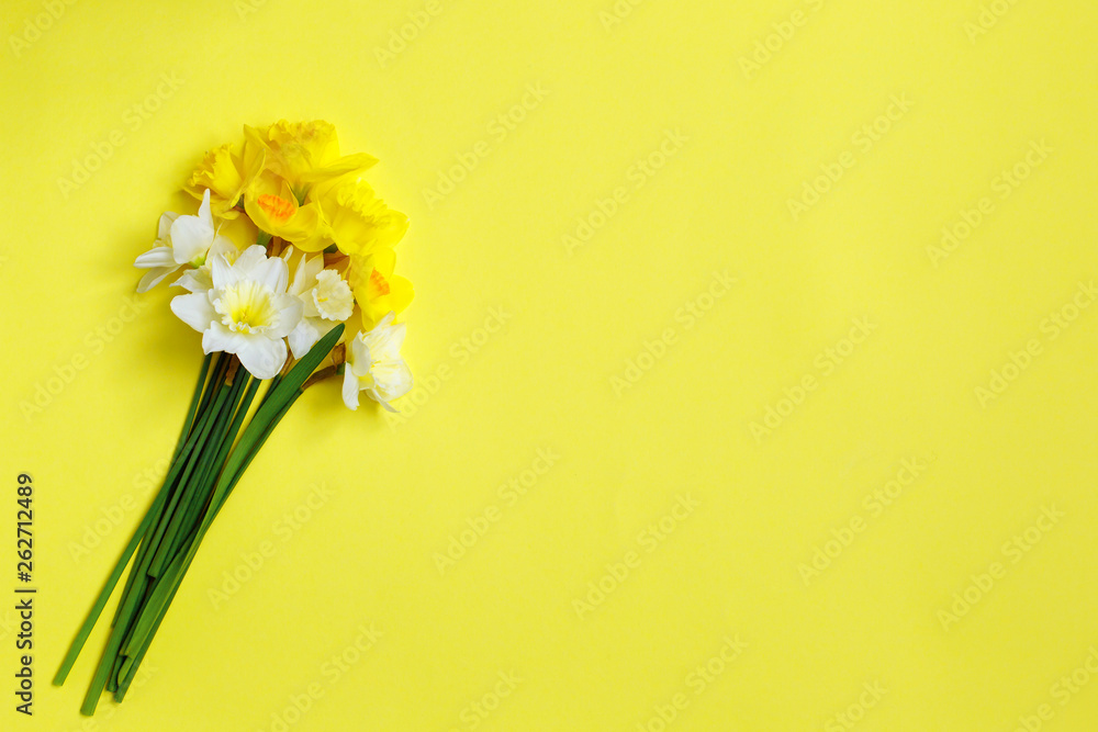 Bouquet of daffodils on a yellow background. Spring yellow flowers. top view, copy space Concept to 8 March, mather day. Spring easter background Bouquet of daffodils on a yellow background. Spring yellow flowers. top view, copy space Concept to 8 March, mather day. Spring easter background