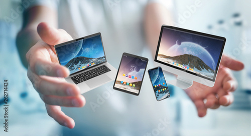 Businessman connecting modern smartphone tablet laptop and computer 3D rendering photo