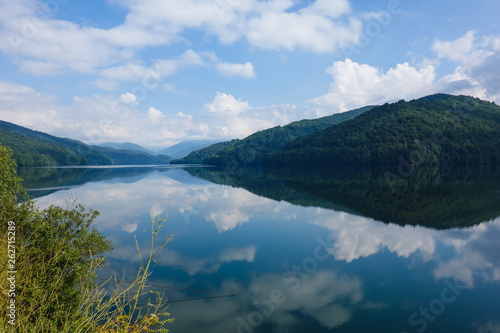 Panorama view including reflections on a mountain lake next to the Transfagarasan Highway, Romania