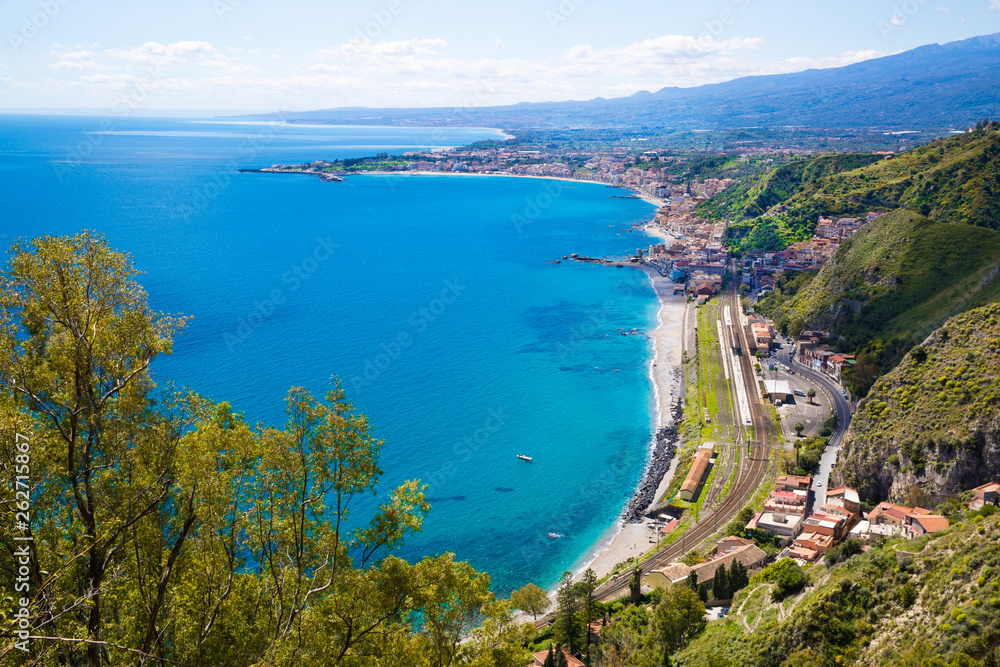 Sicily, Italy. Beautiful panoramic view to Etna volcano and Mediterranean sea (Ionian sea). Bright turquoise waters on summer sunny day. 
