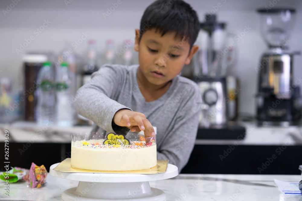 happy kid boy making a cake
