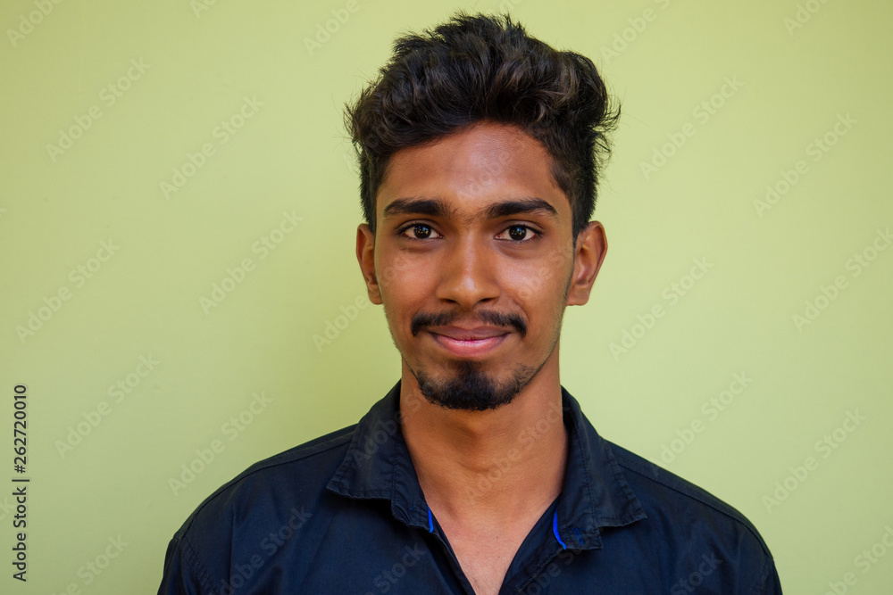 Obraz premium young hindu stylish man posing with sunglasses active beach vacation on semmertime happy Goa India beach. sunscreen spf protection concept.