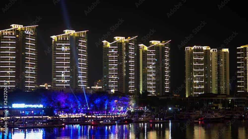 Riverside bay bridge panorama. Night illumination of Sanya streets.