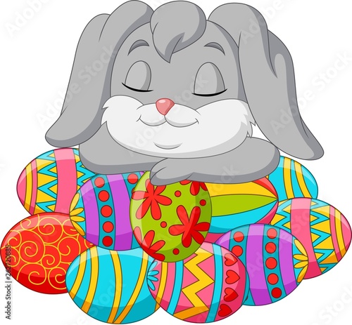 Cute rabbit cartoon sleeping on Easter eggs
