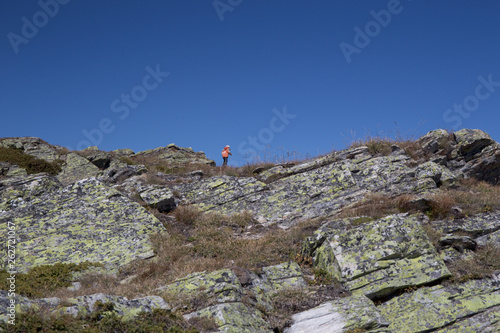 A young hiker on some rocks of a mountain.
