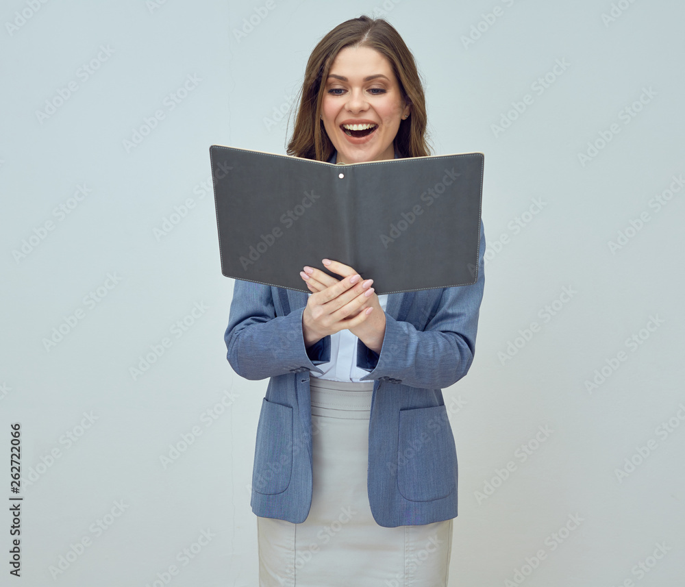 Young woman teacher wearing suit holding open book. Young woman teacher wearing suit holding open book.