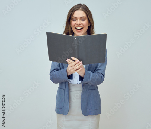 Young woman teacher wearing suit holding open book. © Yuriy Shevtsov