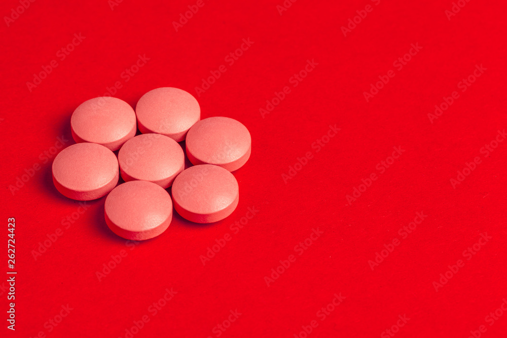 Top view of pharmaceutical medicine pills on red background Top view of pharmaceutical medicine pills on red background