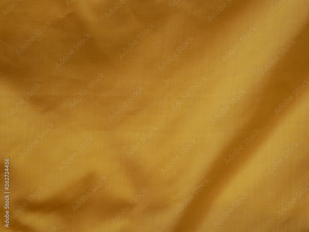 Naklejka premium golden silk fabric background