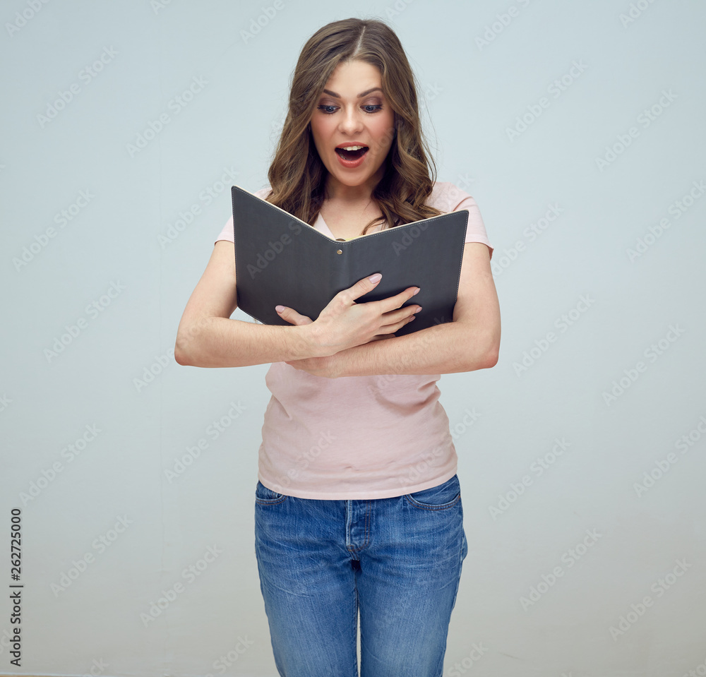 smiling girl holding open book in front of him. smiling girl holding open book in front of him.